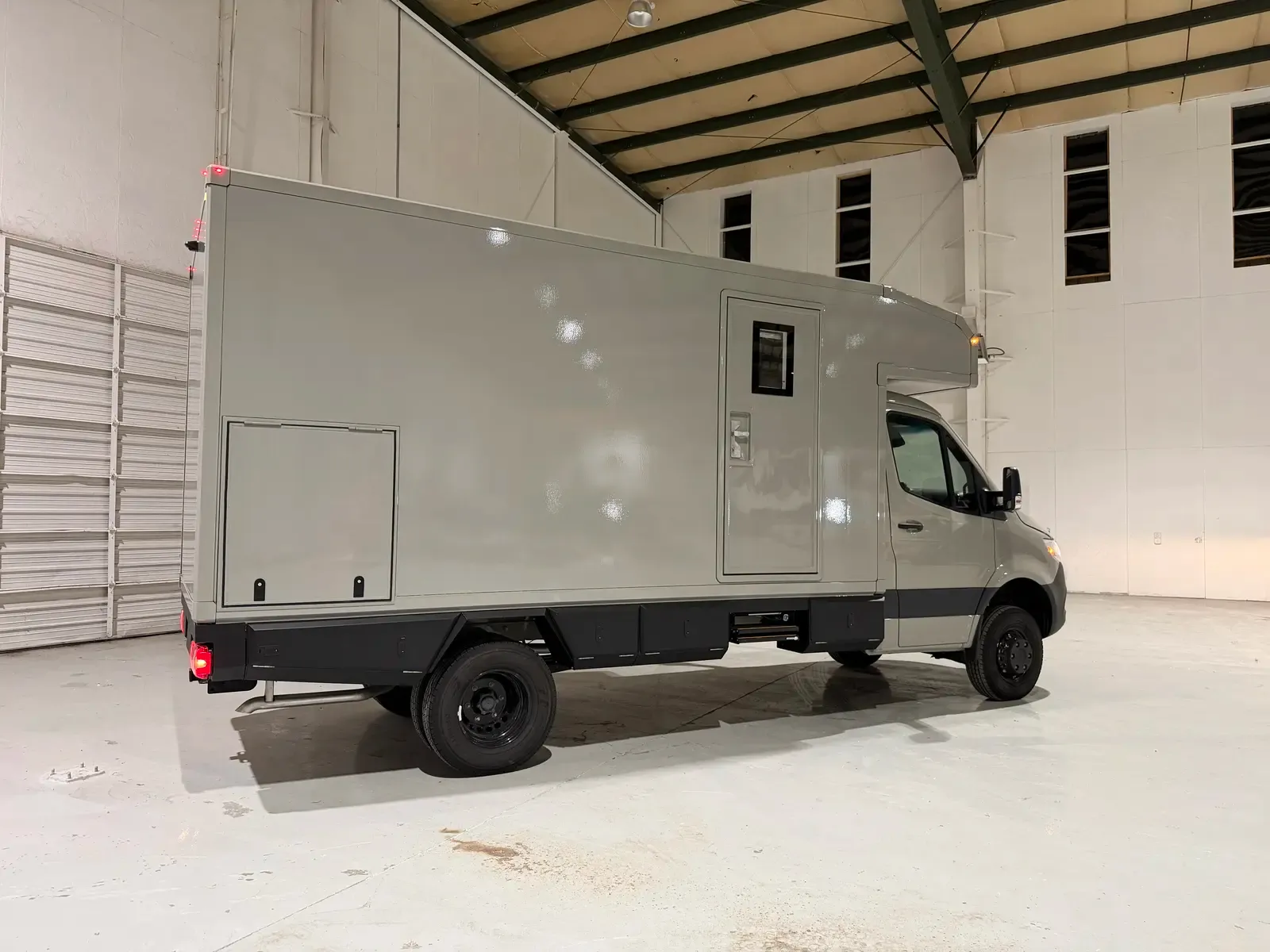 Stone Gray Mercedes-Benz Sprinter 170 composite camper, rear three-quarter view