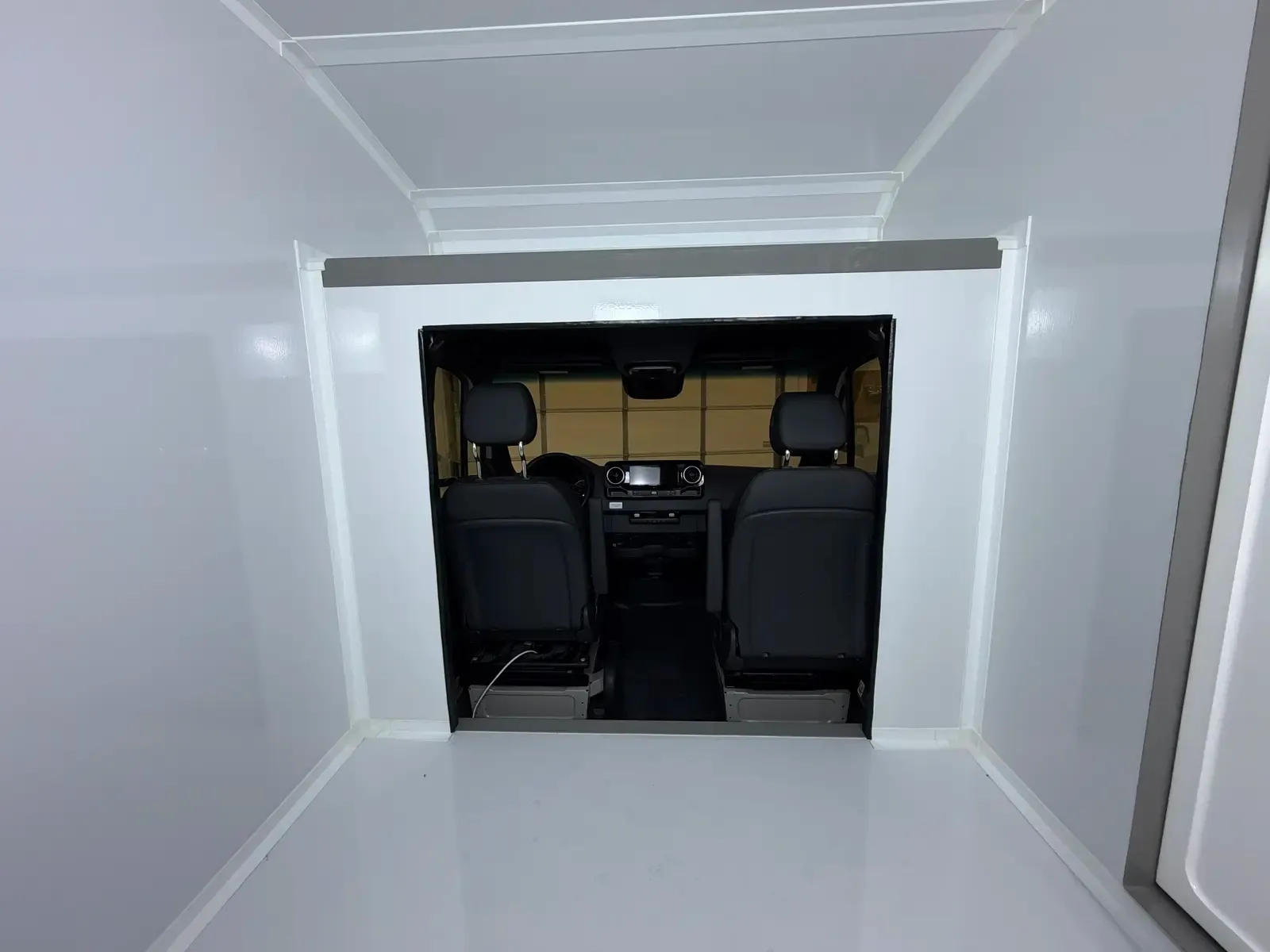 Inside the Voyager's composite body, cab pass-through framing the front seats